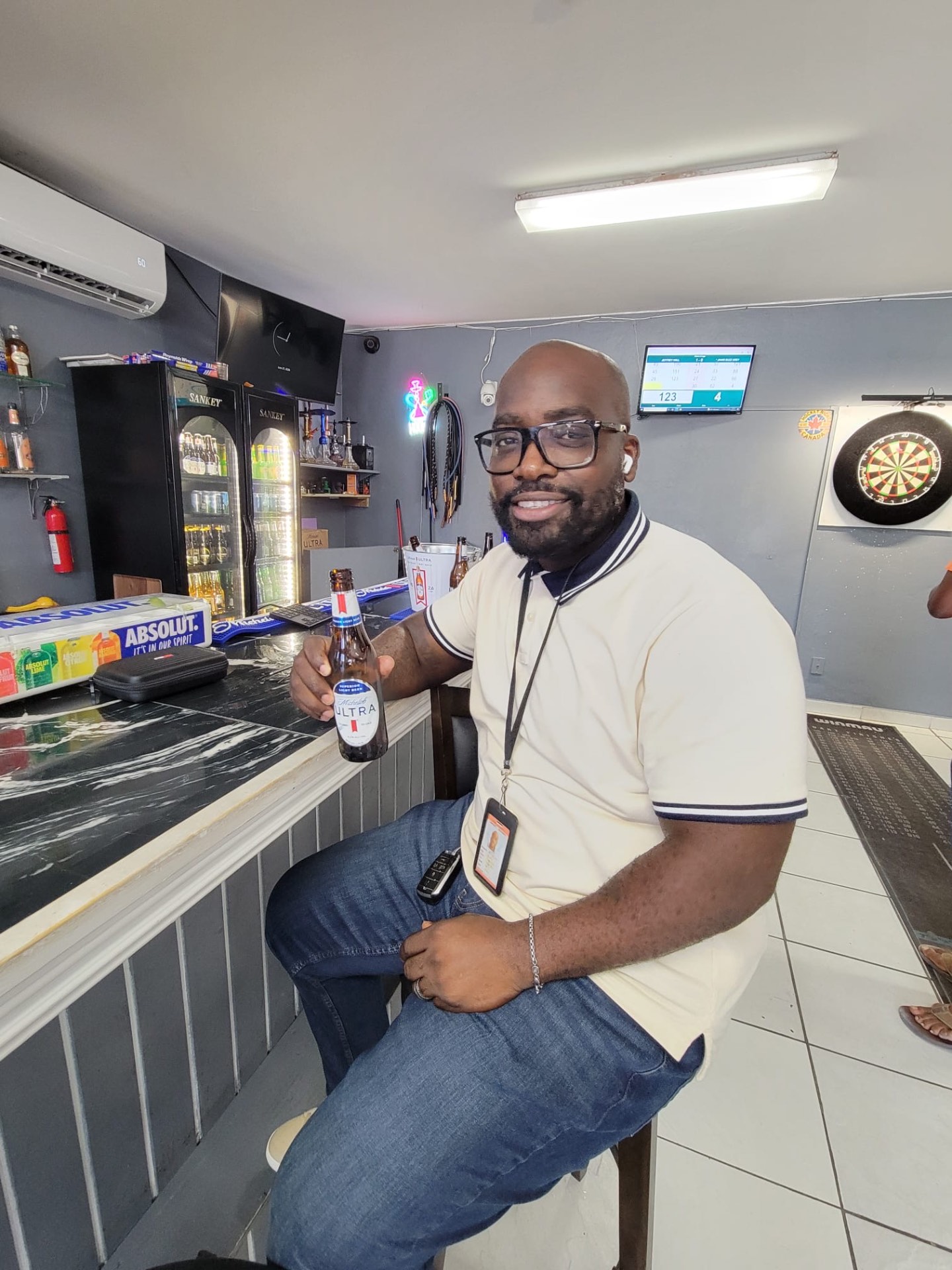 Player at the bar with dartboard